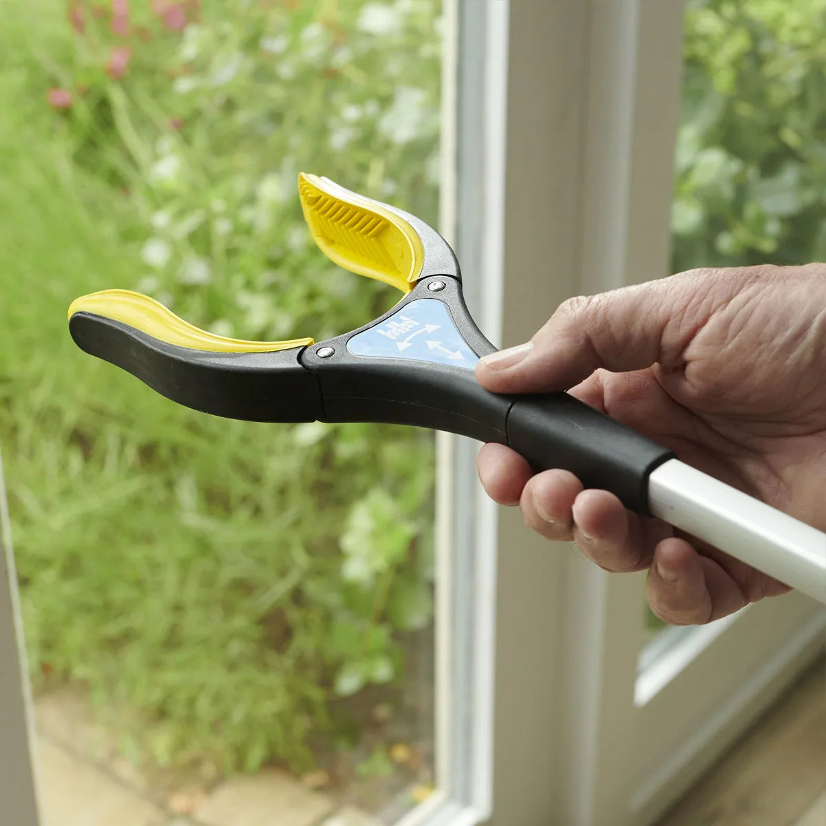 Someone rotating the end of a grip reacher.