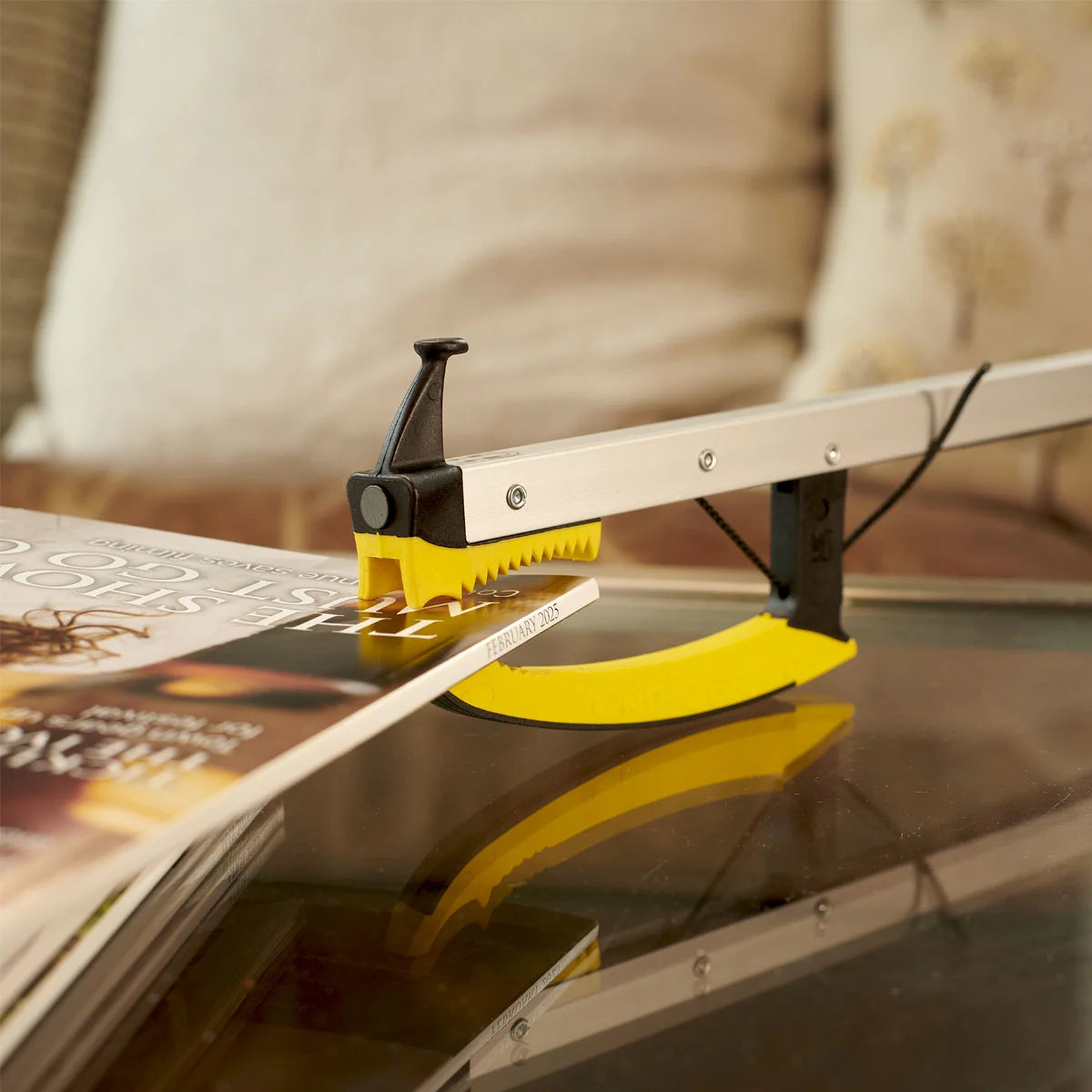Someone is using a pair of tongs to grab a magazine