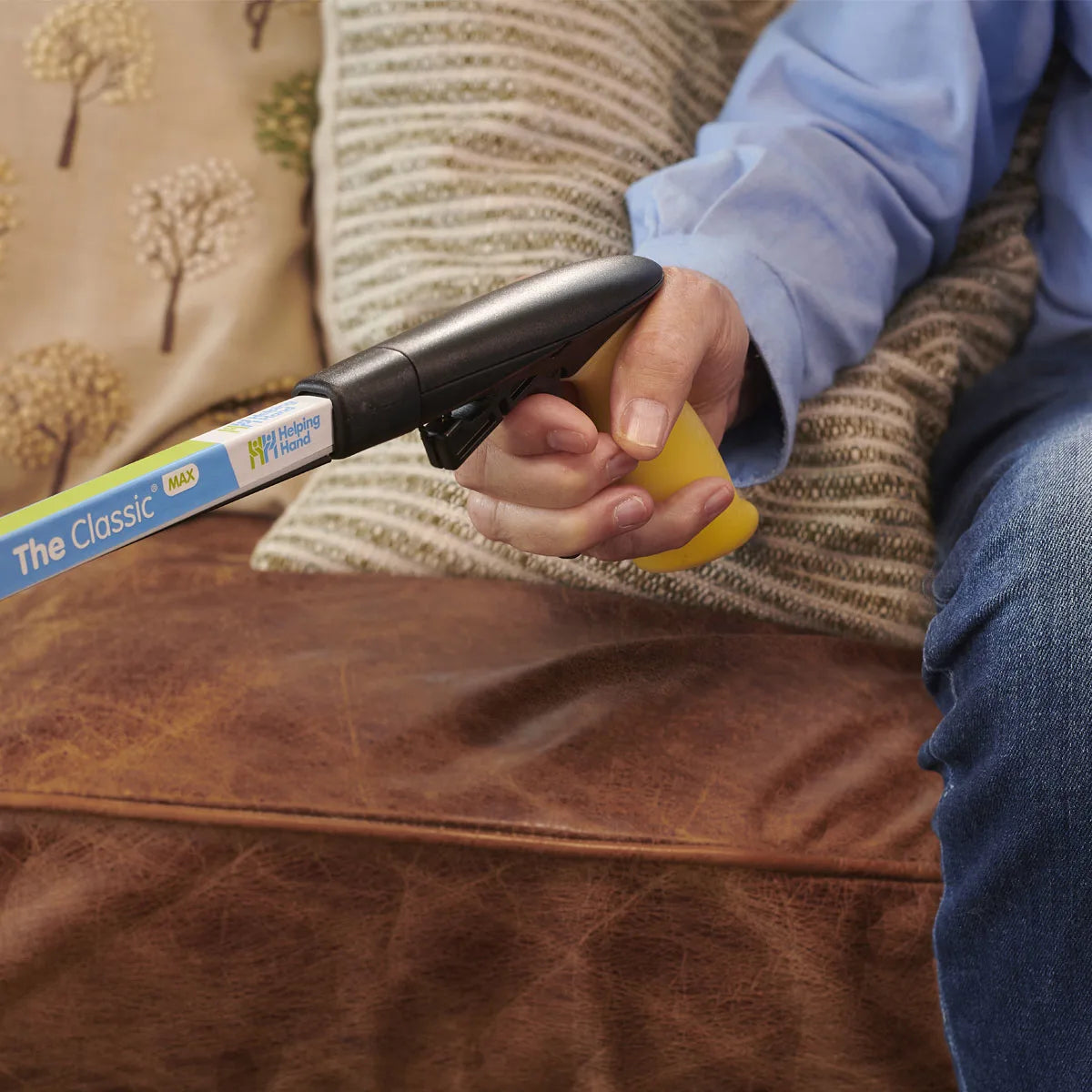 A person holidng a max gel handle reacher
