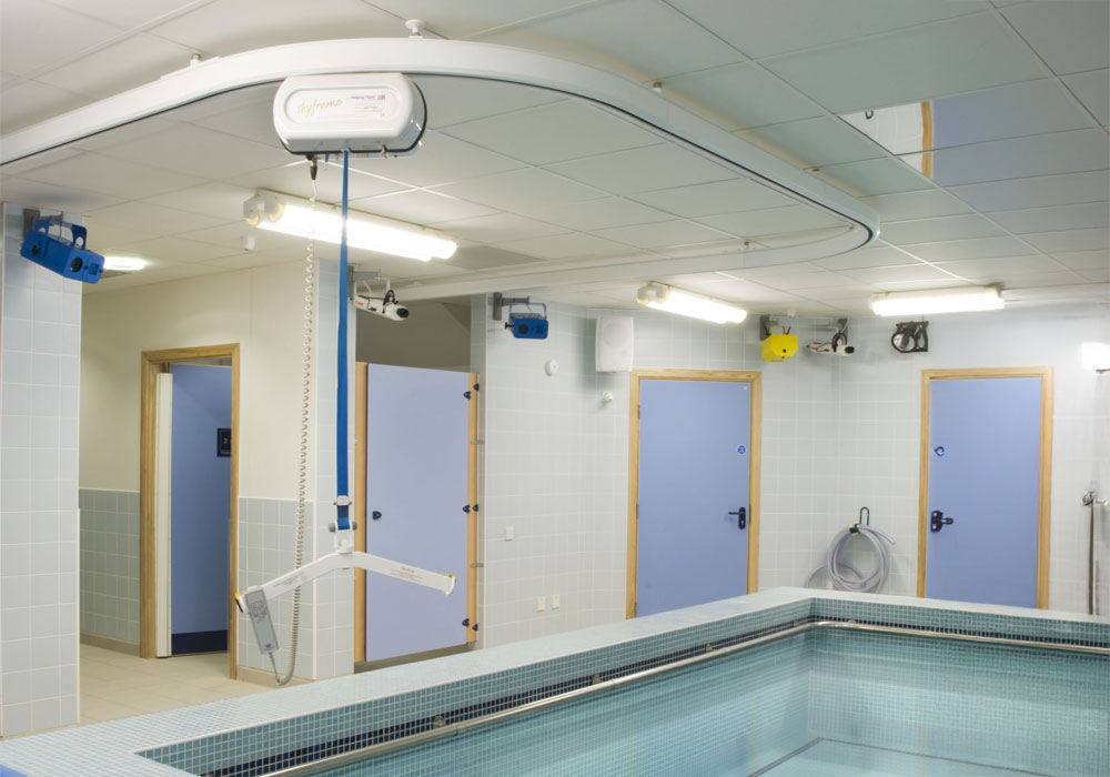 Indoor pool with accessibility features such as ceiling mounted Skyframe.
