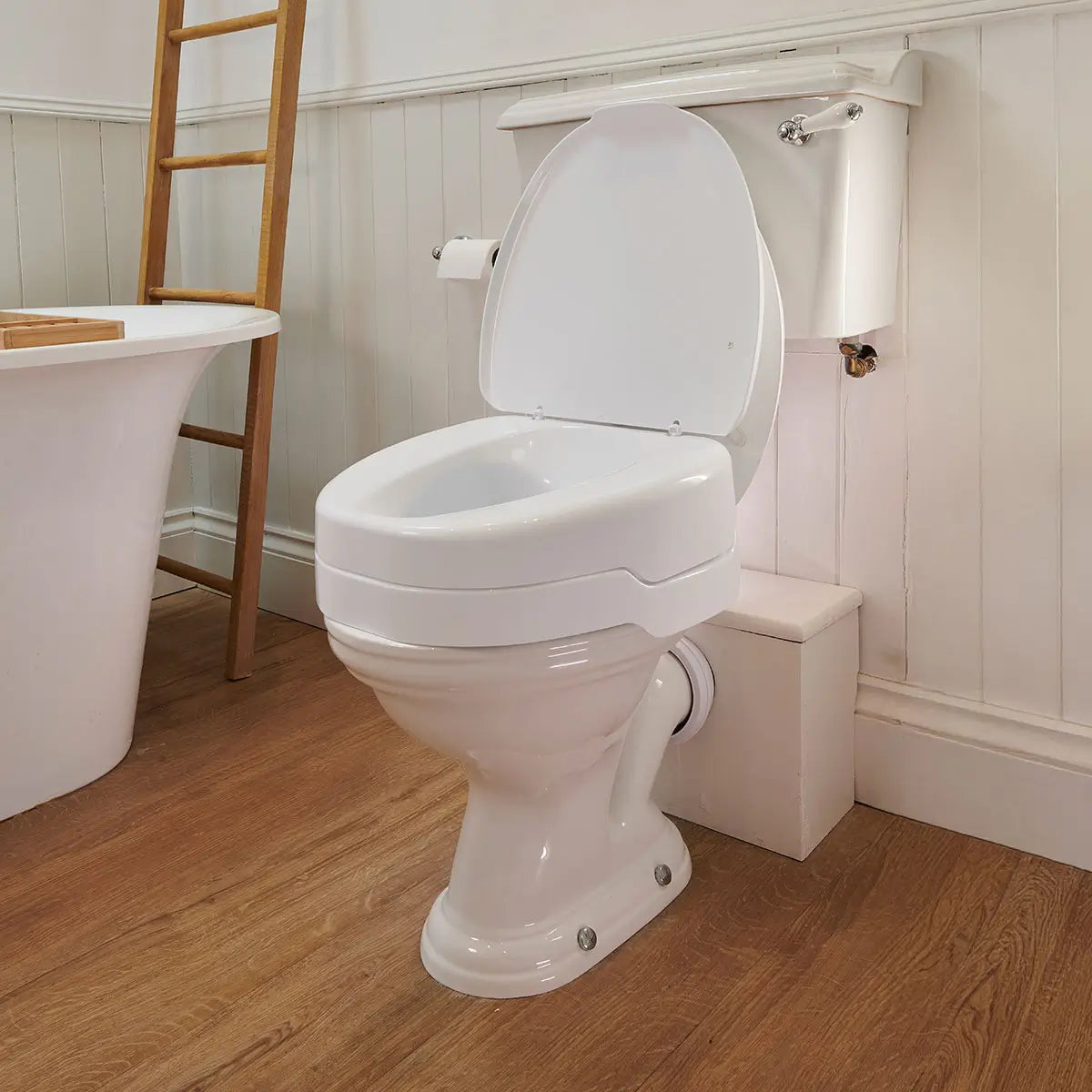 White toilet Ezy Fit raise toilet seat 4 inches with open lid in a bathroom setting.