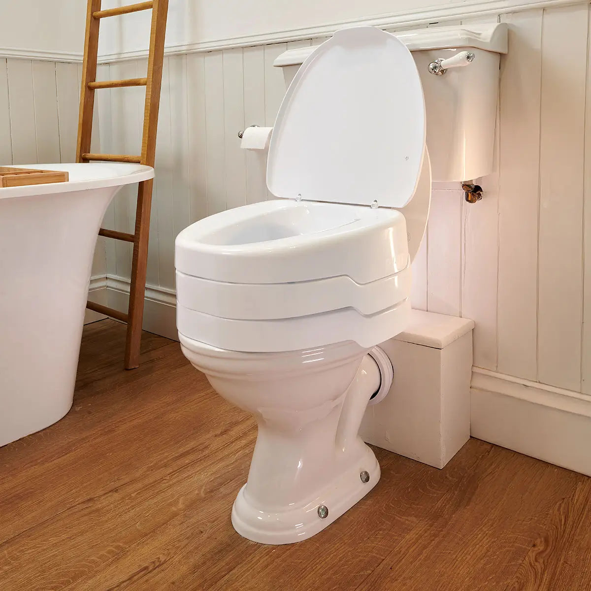 White Ezy Fit Raise toilet with adjustable seat in a bathroom setting.