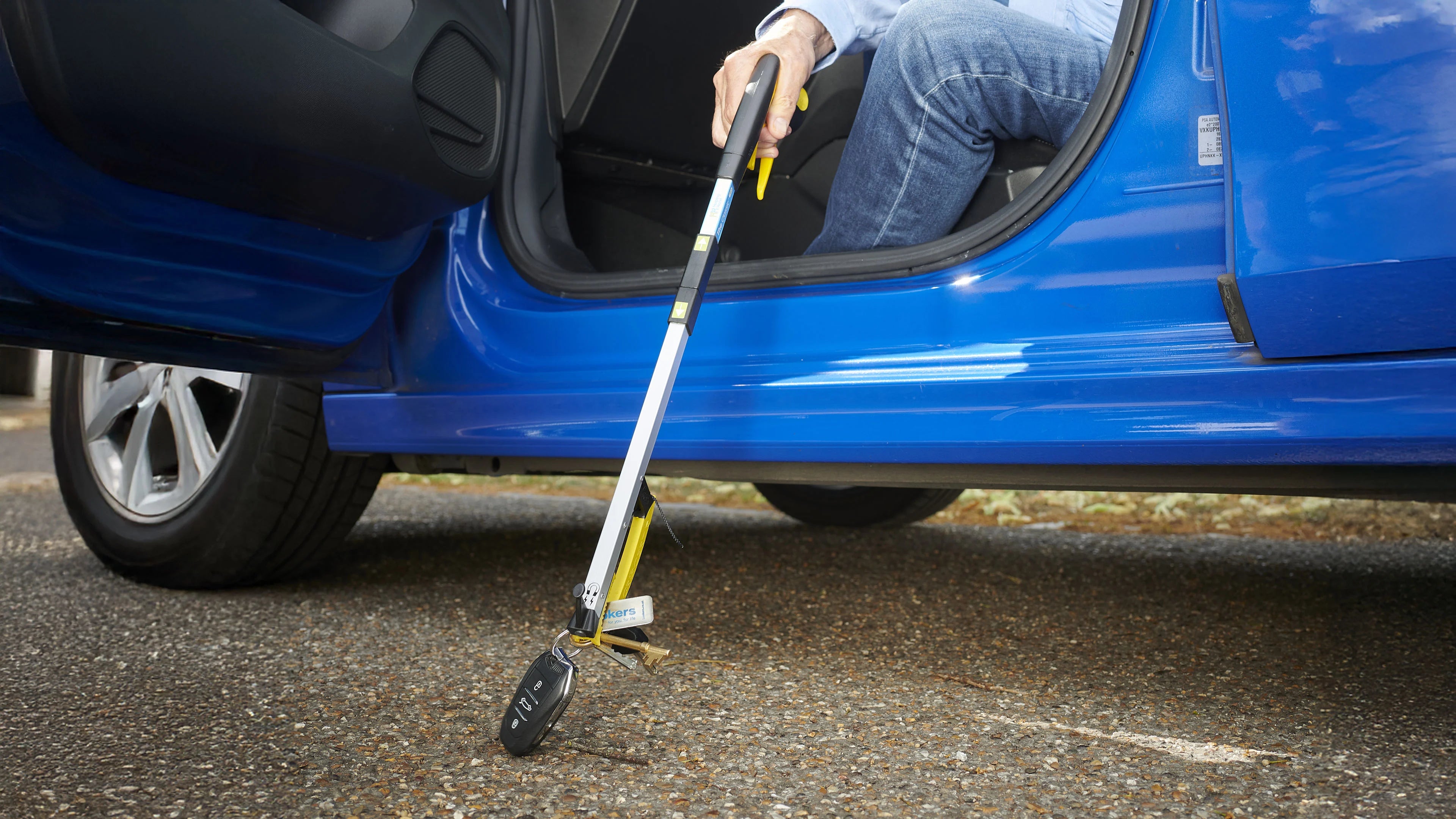 Someone picking up car keys of the floor with the pro folder