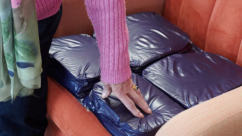 Person getting ready JAY EquaZone Air Wheelchair cushion.