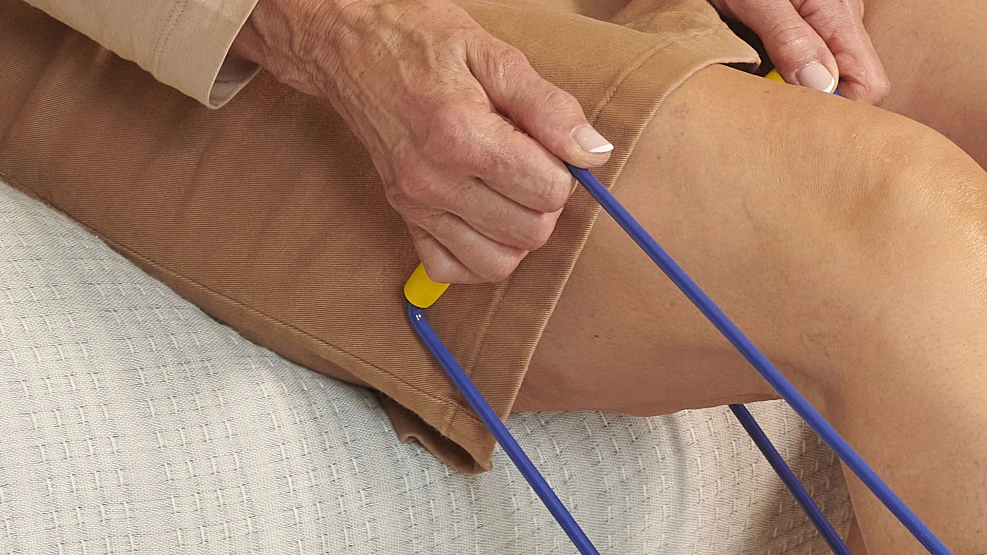 A person holding bars to a sock aid