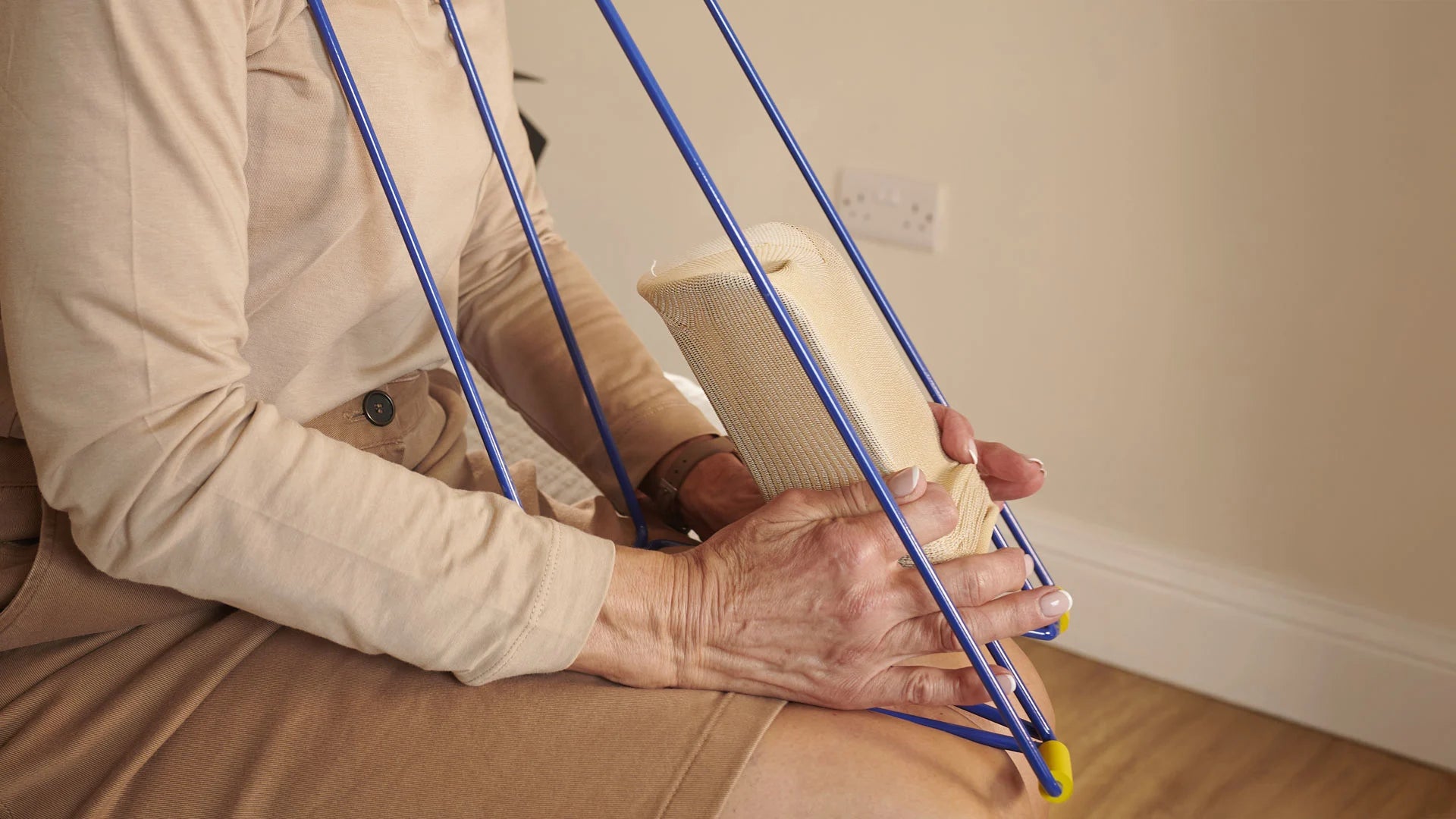 A person putting socks onto a sock aid