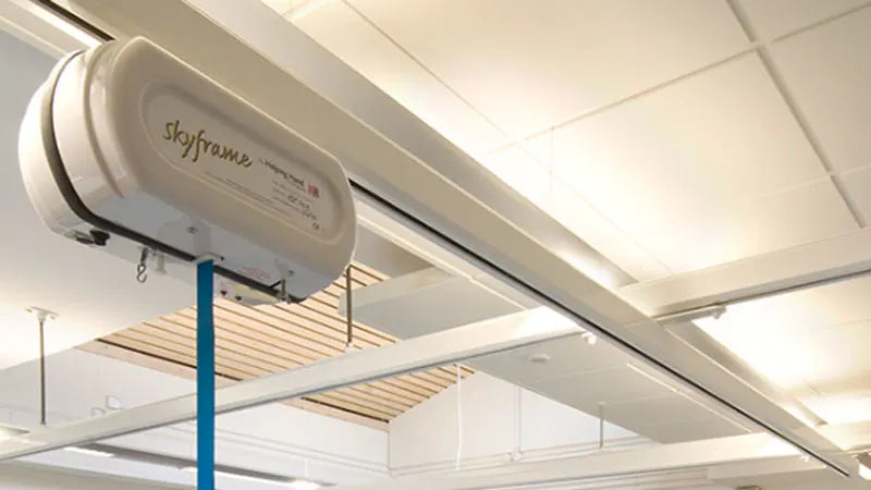 Ceiling-mounted skyframe medical device in hospital.