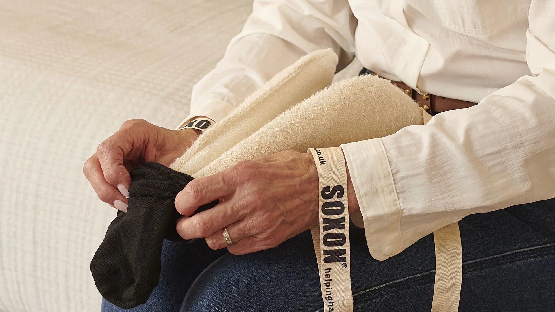 Person putting socks onto a sock aid