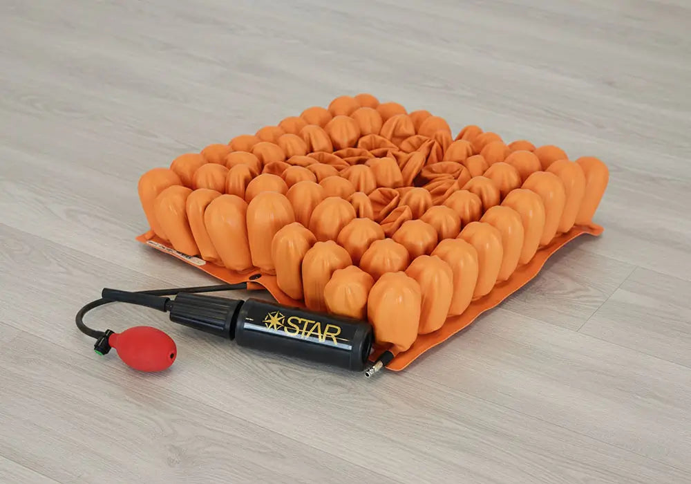 Starlock air cushion with pump on a wooden surface.