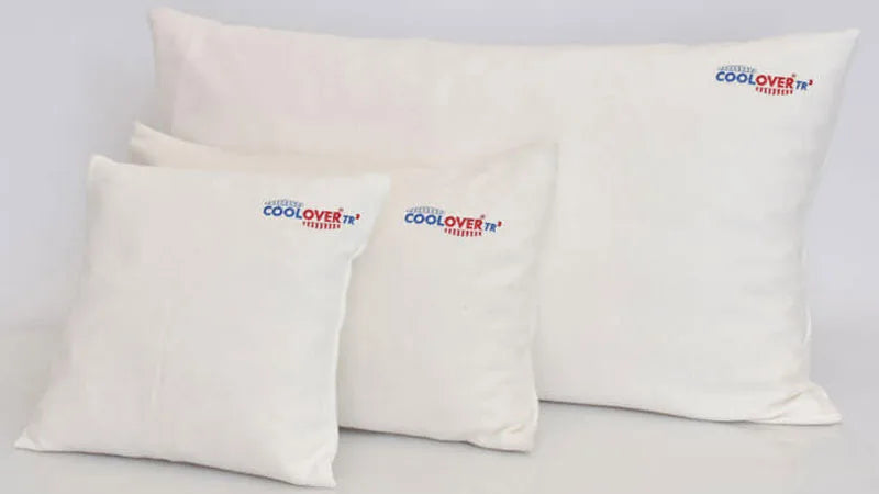 Three white pillows with 'COOLOVER' branding on a light gray background