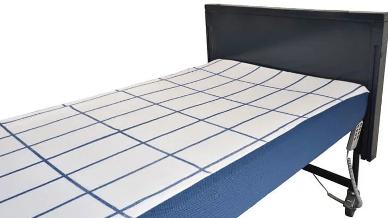 Bed with a blue and white checkered mattress cover on a white background