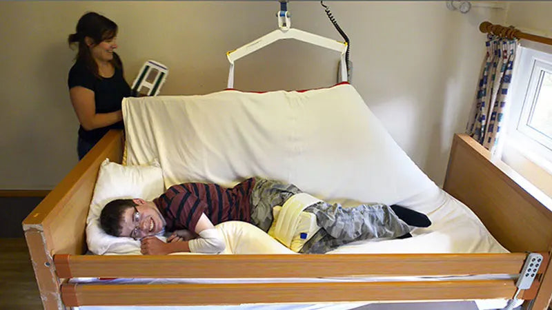 Child lying in a symmslyde support bed.
