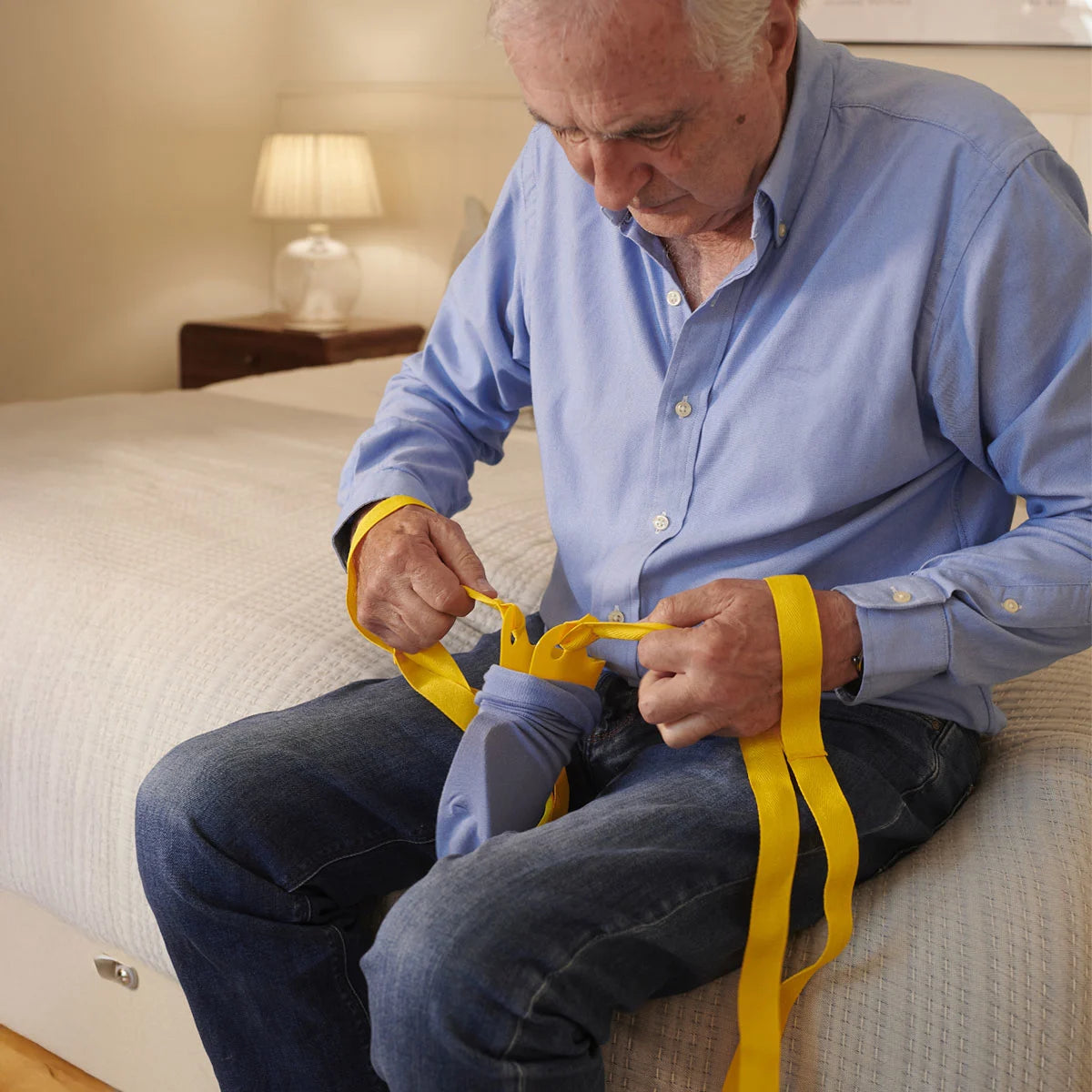 A person putting socks onto the foxy sock aid