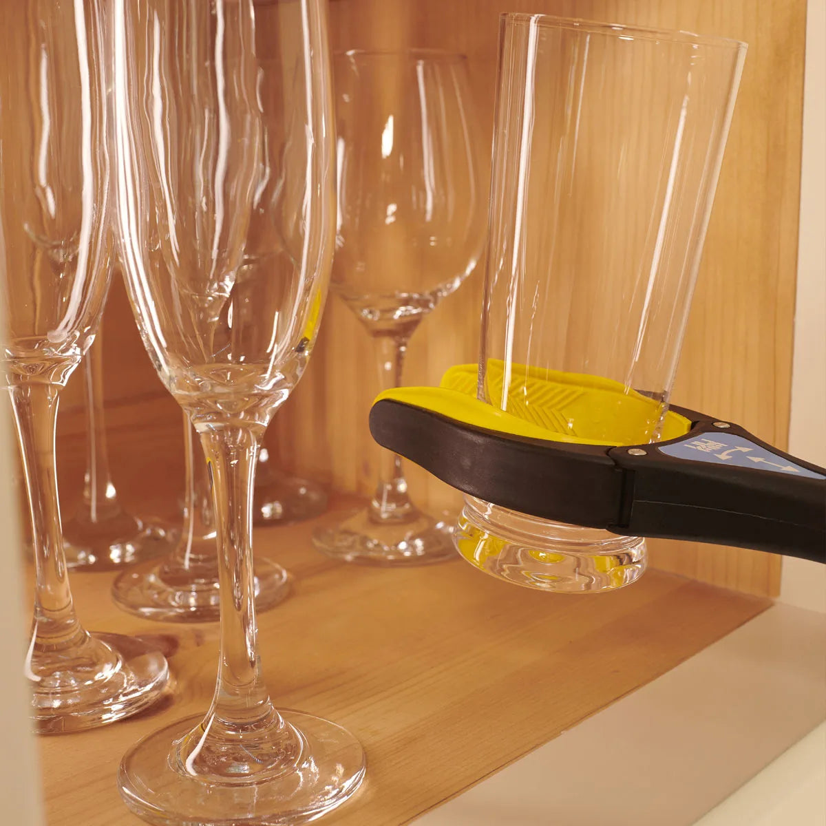 Someone using the grip max reacher to get a glass cup