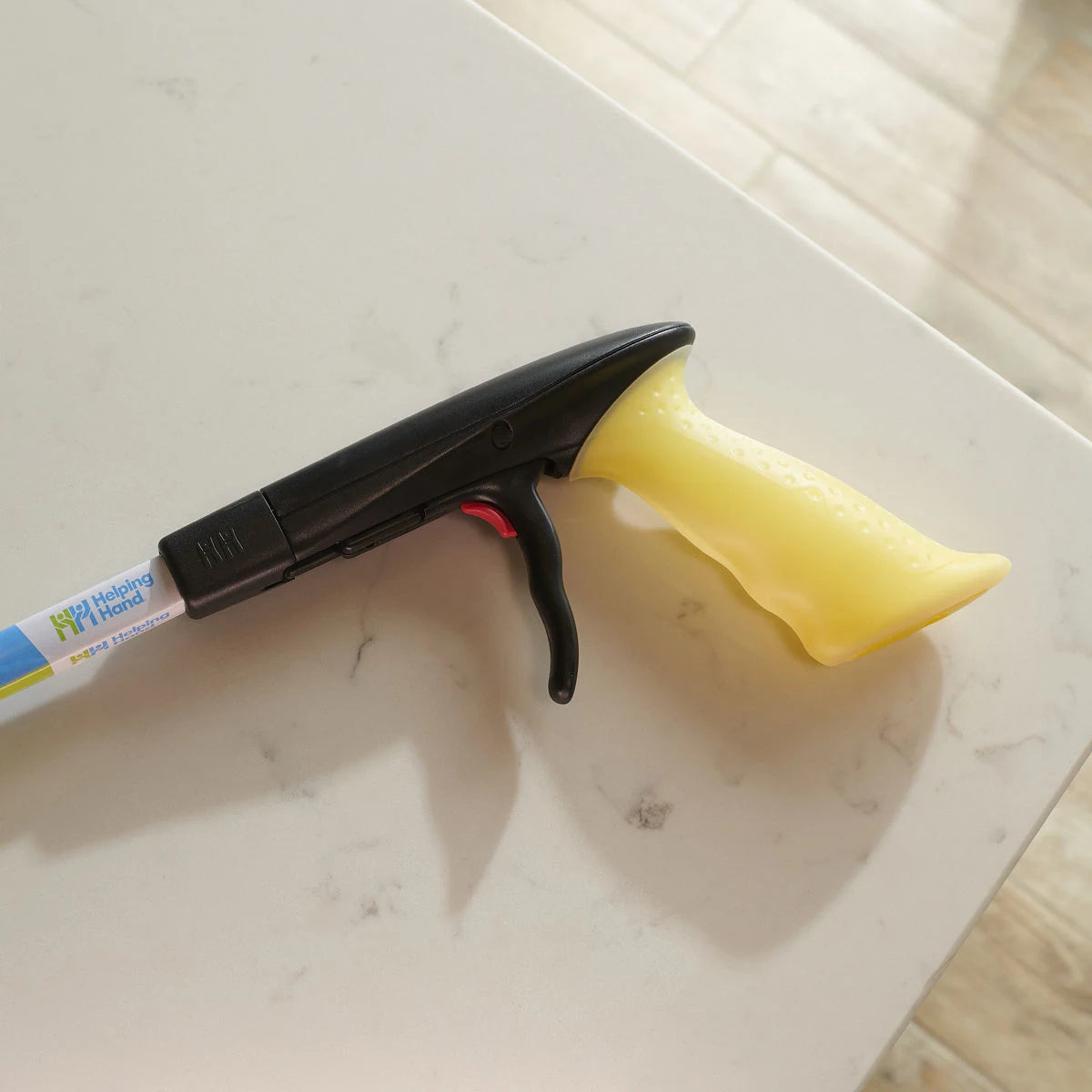 a hand held yellow tool on a white table