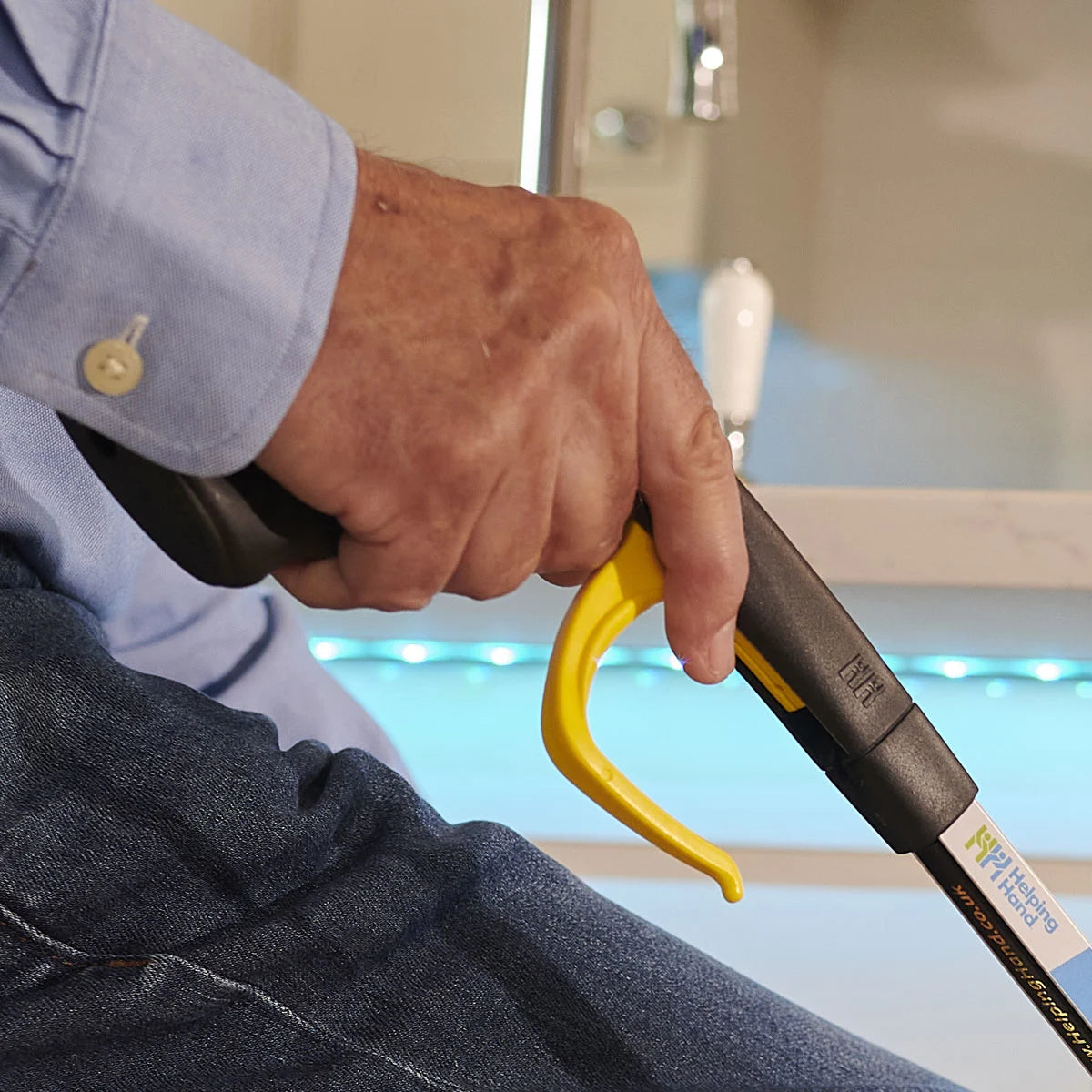 A person holding the handi grip pro reacher