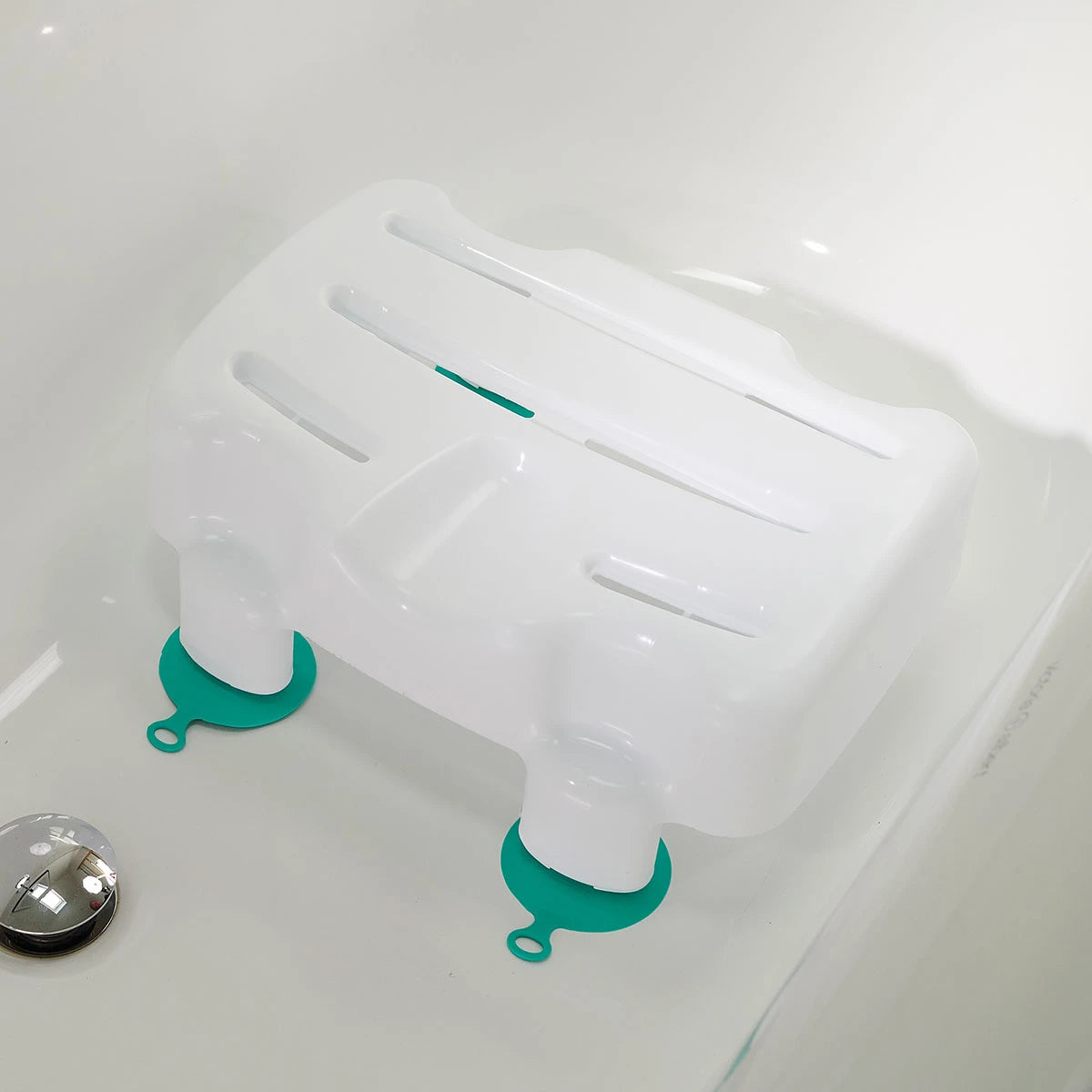 White plastic bathtub seat with green anti-slip cups on a white bathtub