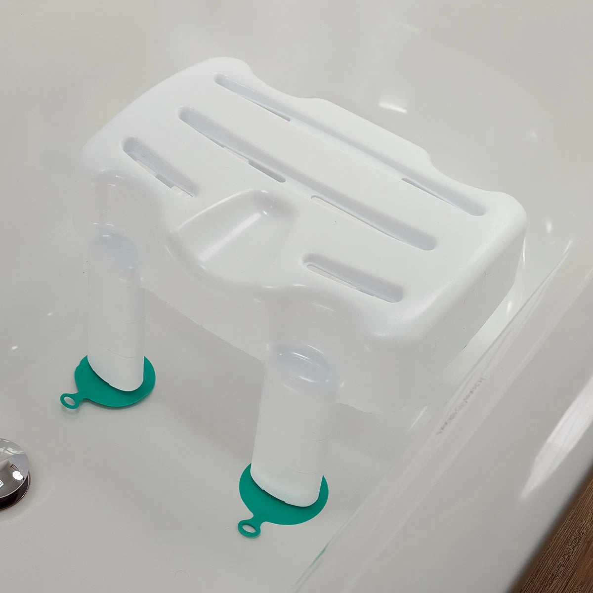 A bath seat with green anti-slip feet with an adjusted height
