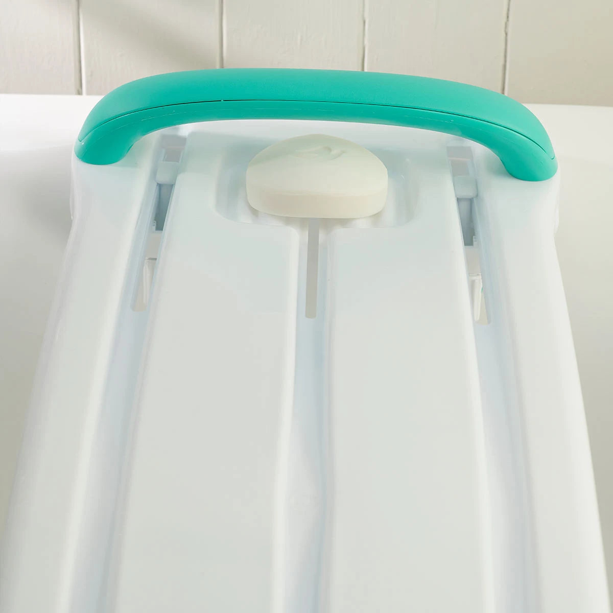 White board with a turquoise handle and white soap bar