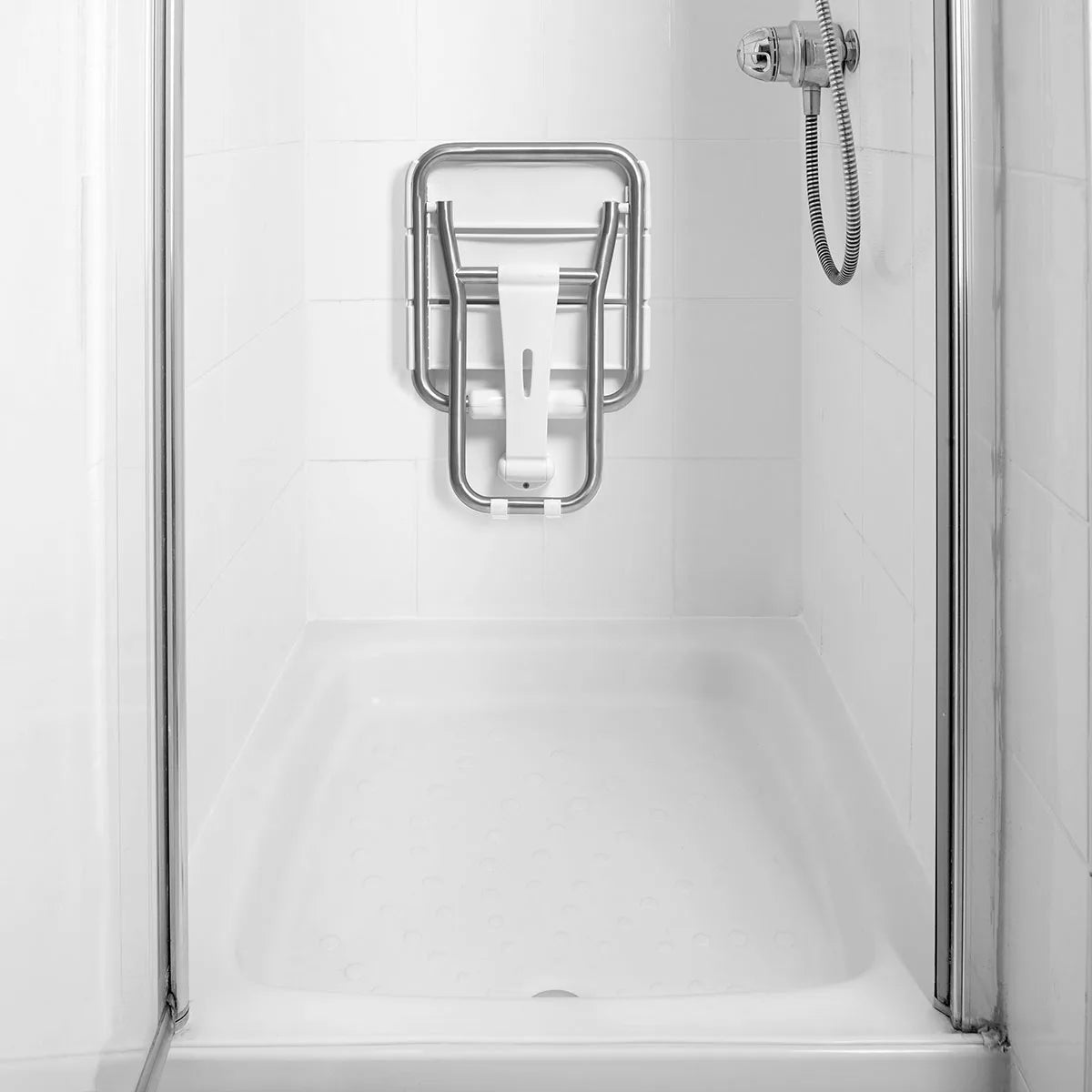 Metal grab bar mounted on a shower wall with clear glass doors.