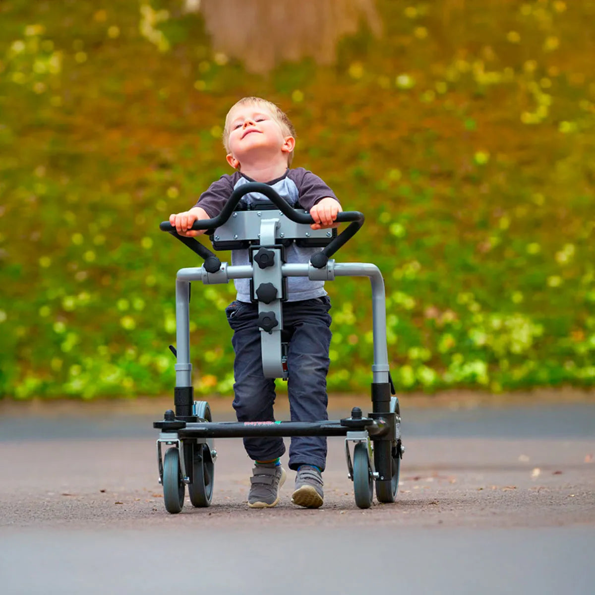 Child using Meywalk gait trainer outdoors.