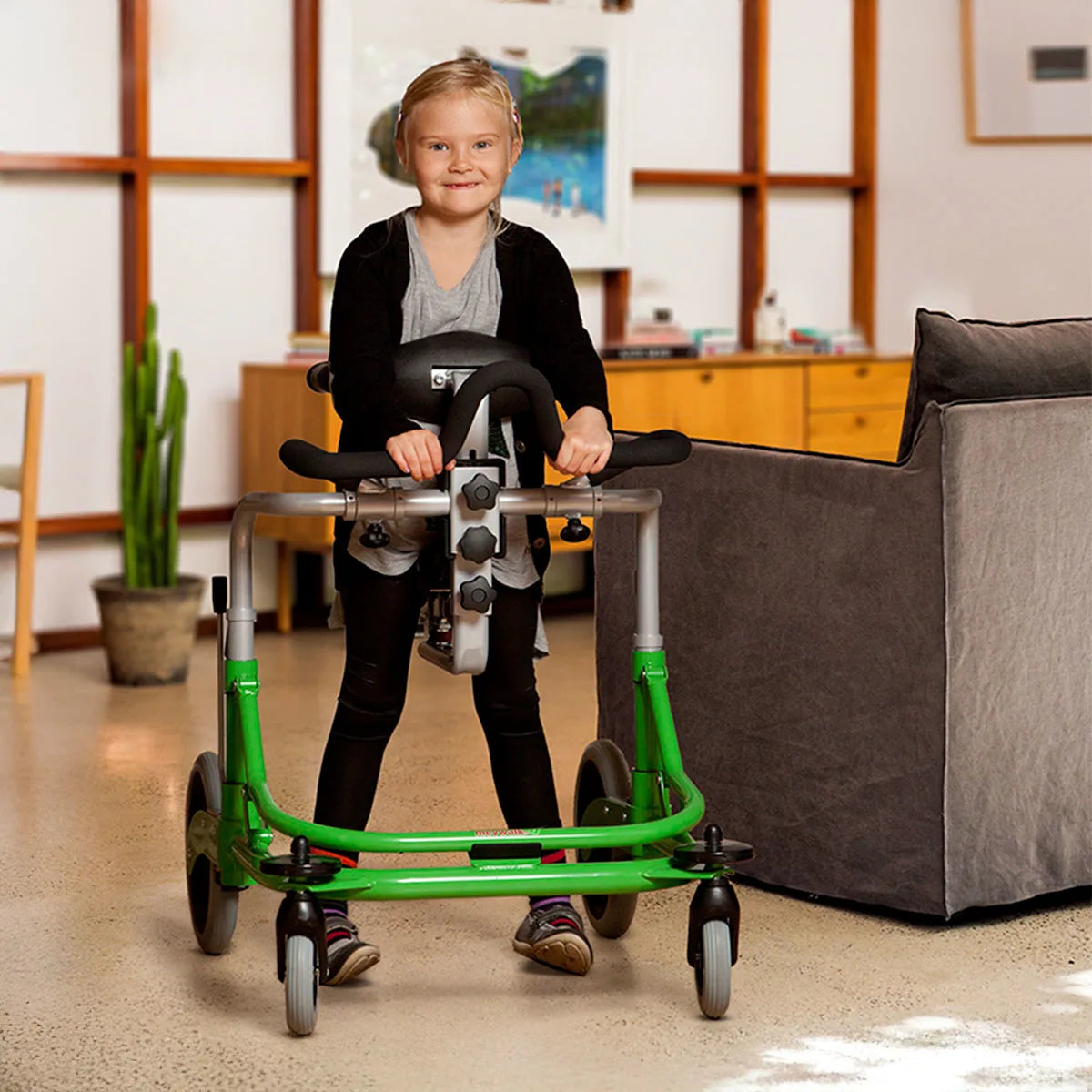 Child using the Meywalk walker gait trainer in living room.