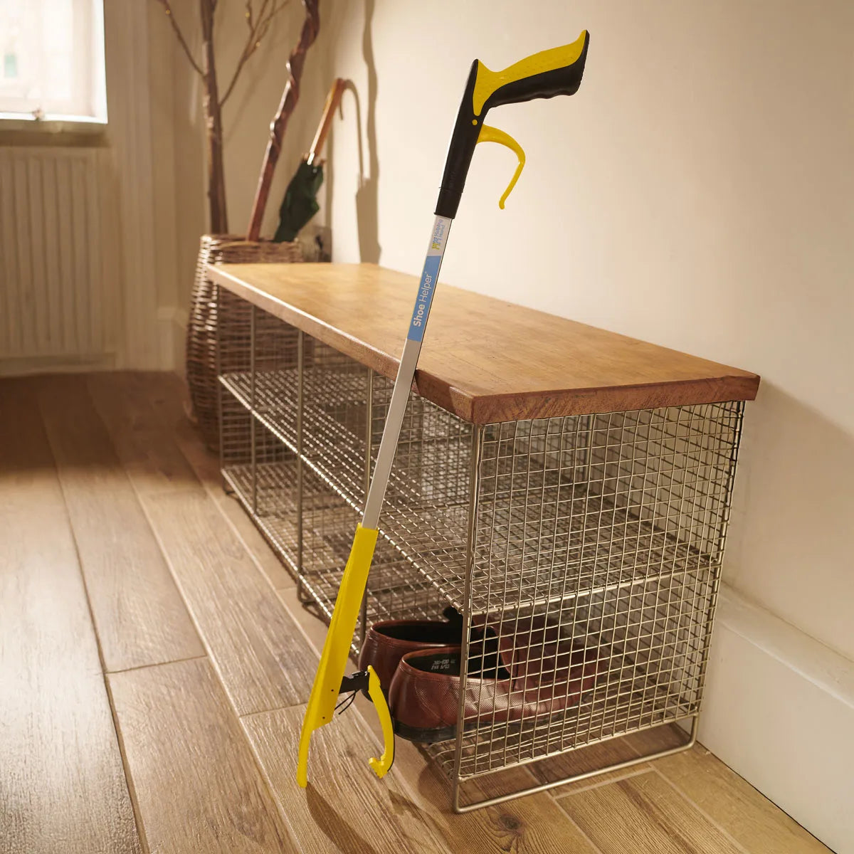 A yellow shoe helper grabber