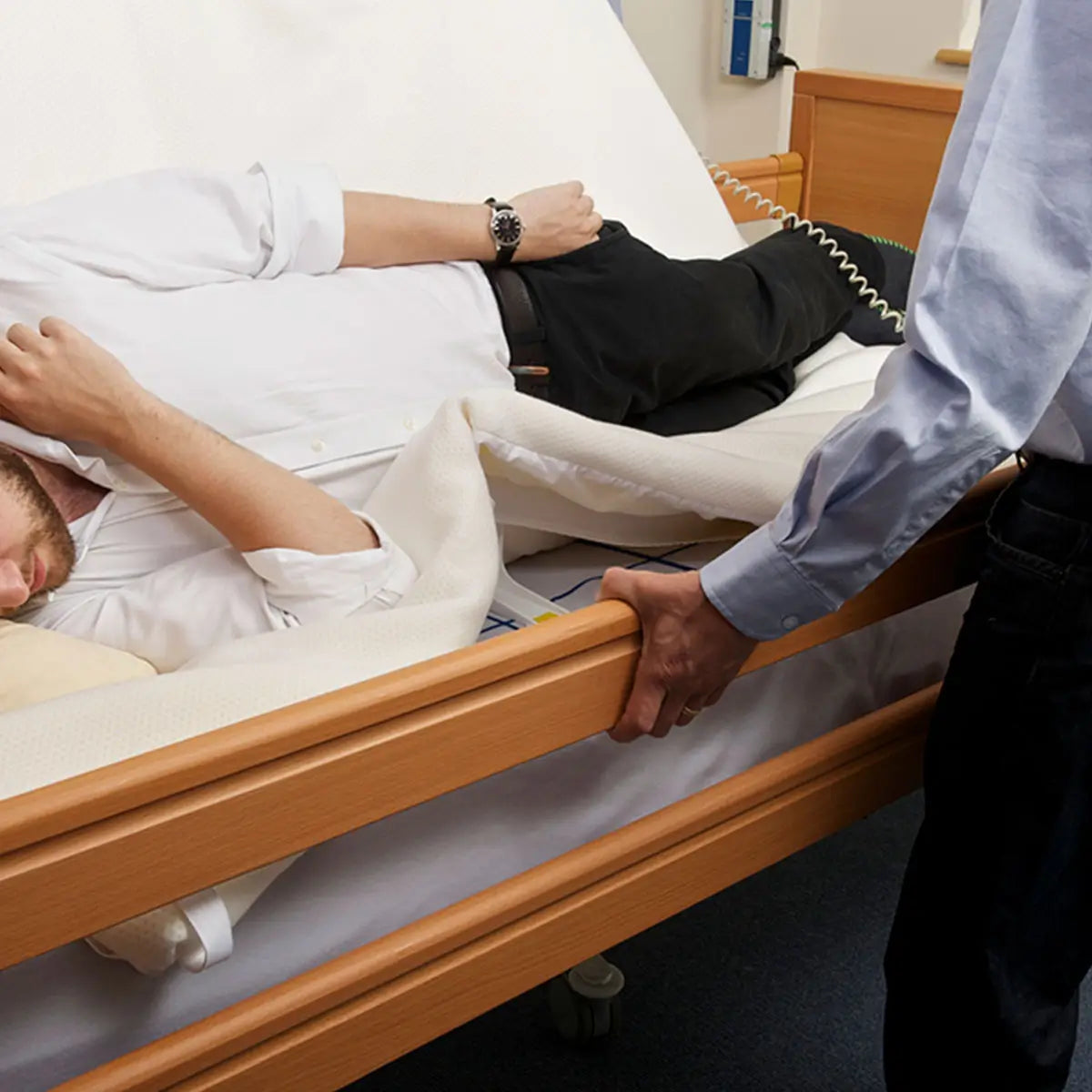 Man lying on Symmslyde 24 hour care.