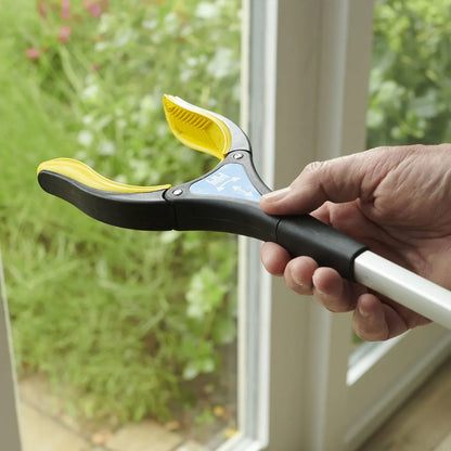 Someone rotating the end of a grip reacher.