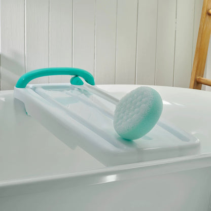 Turquoise bath sponge attachment on a bathtub table