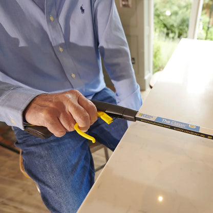 A person is holding the classic pro reacher grabber 