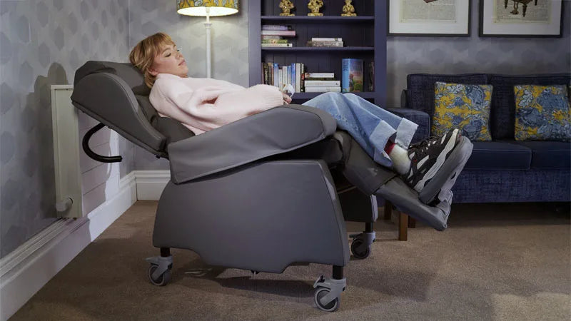 Person using a recliner chair in a living room setting.