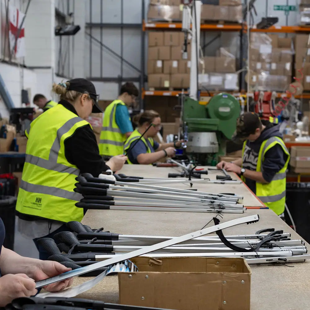 Helping Hand factory employees assembling grabbers.