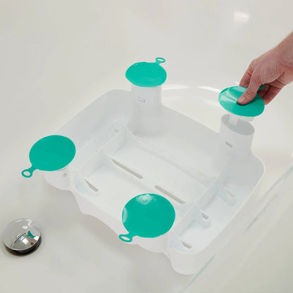 Bath tub with a white bath seat and green suction cups on a white background