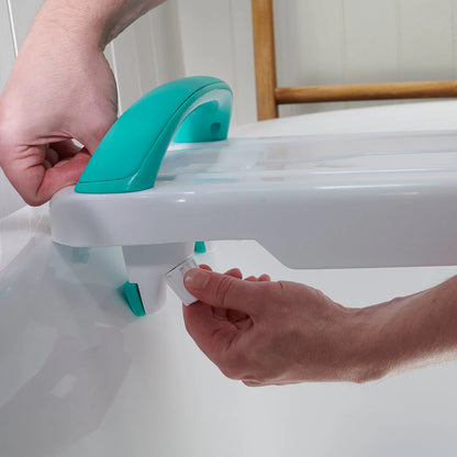 A person adjusting a bath support device with a handle