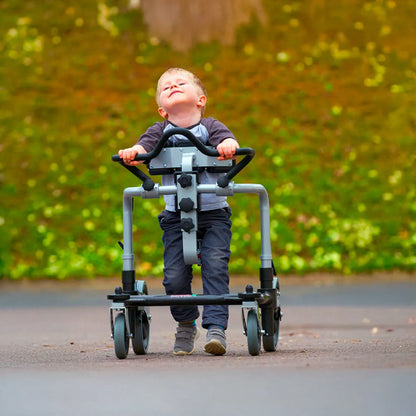 Child using Meywalk gait trainer outdoors.