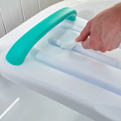 Person using a bath shoer board with a turquoise handle